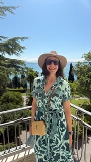 Sandra Hodes wearing a sun hat in a garden overlook