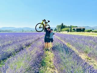 Sandra Hodes holding a bicycle in a lavender field
