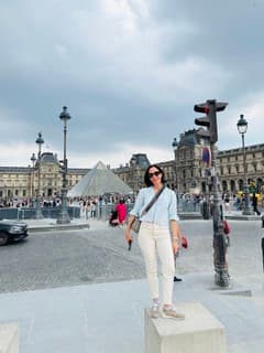 Sandra Hodes walking through a Paris square